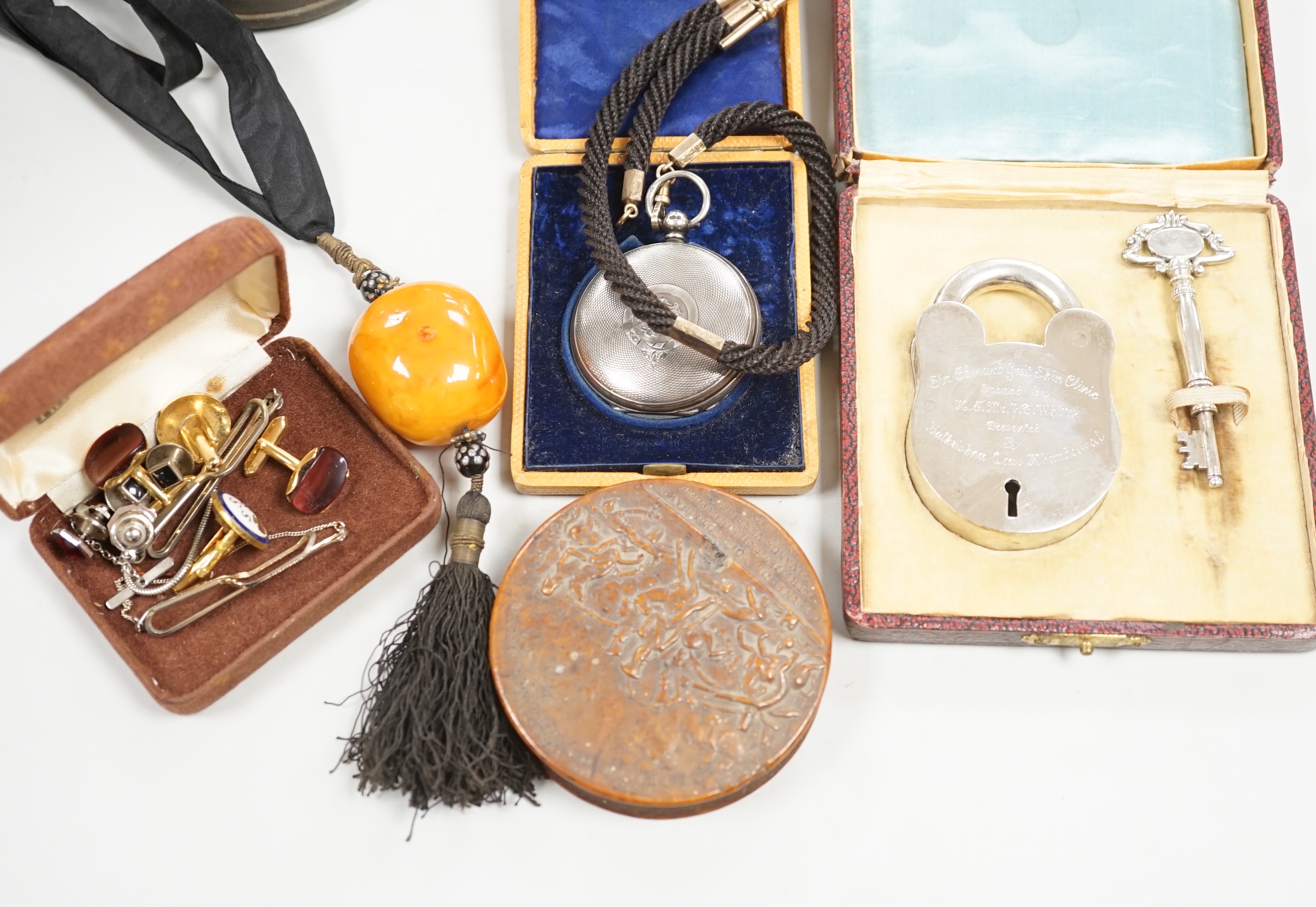 A group of 19th century and later collectibles to include a silver plated presentation padlock and key, a silver hunter pocket watch, french snuff box, etc.